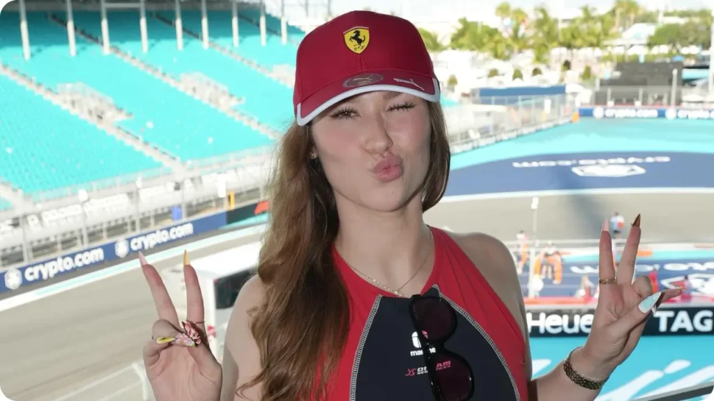 Sondra blust wearing ferrari cap and victory sign